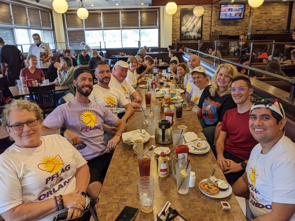 Group of volunteers eating lunch at a restaurant.